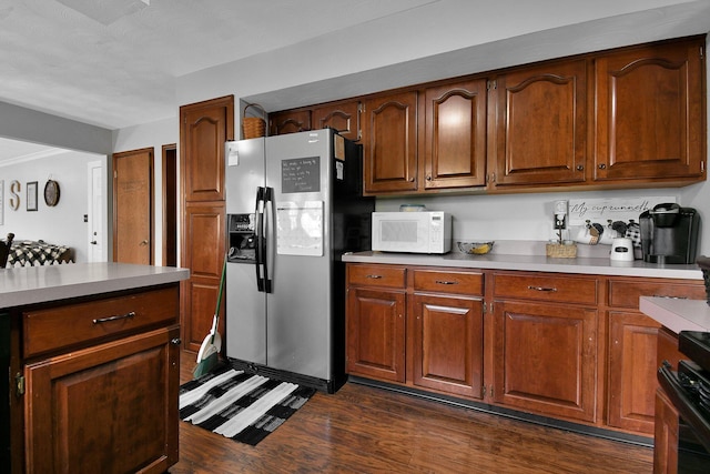 kitchen featuring electric range, dark hardwood / wood-style flooring, and stainless steel refrigerator with ice dispenser