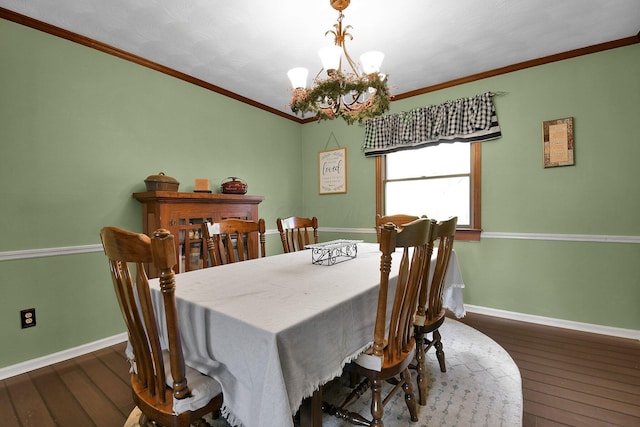 dining space with dark hardwood / wood-style flooring, a chandelier, and ornamental molding