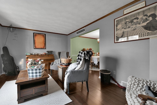 living room with crown molding and dark wood-type flooring