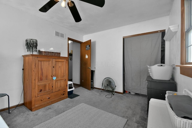 interior space featuring ceiling fan and carpet