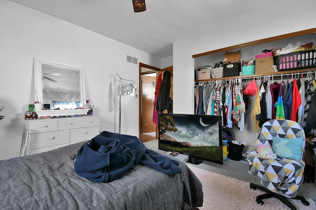 bedroom featuring ceiling fan, a closet, and light colored carpet