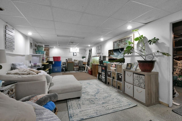 carpeted living room featuring a paneled ceiling