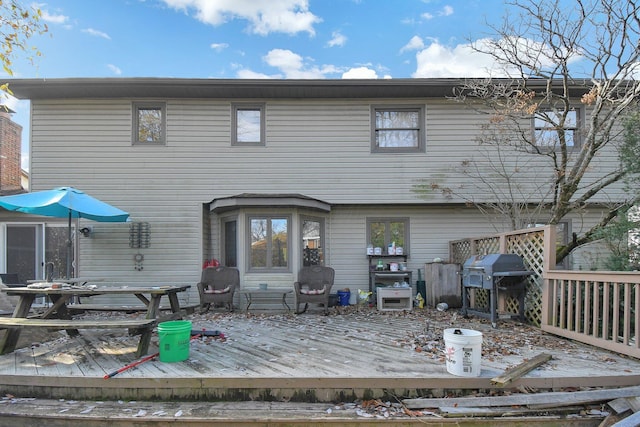 back of property featuring a wooden deck