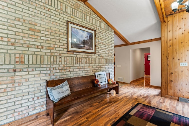 interior space featuring vaulted ceiling with beams and light hardwood / wood-style flooring