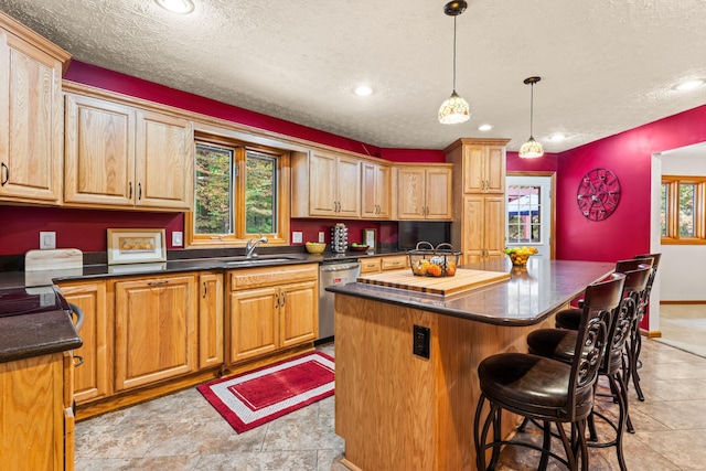 kitchen with stainless steel dishwasher, a kitchen island, and a textured ceiling