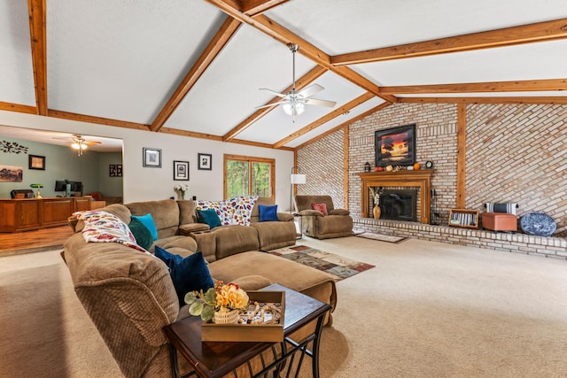 carpeted living room featuring ceiling fan, lofted ceiling with beams, brick wall, and a brick fireplace