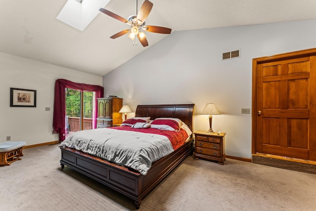 carpeted bedroom with lofted ceiling with skylight and ceiling fan