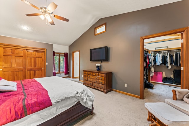 carpeted bedroom with ceiling fan, lofted ceiling, and a closet