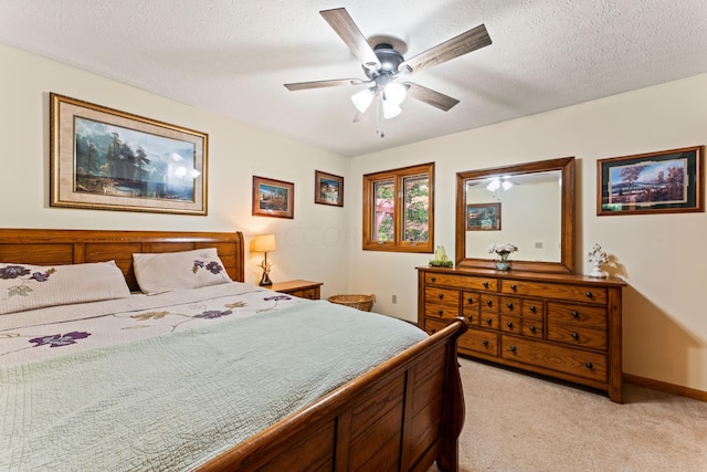 carpeted bedroom with a textured ceiling and ceiling fan