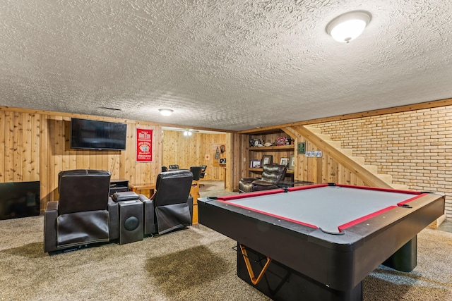 playroom with carpet, a textured ceiling, and wooden walls