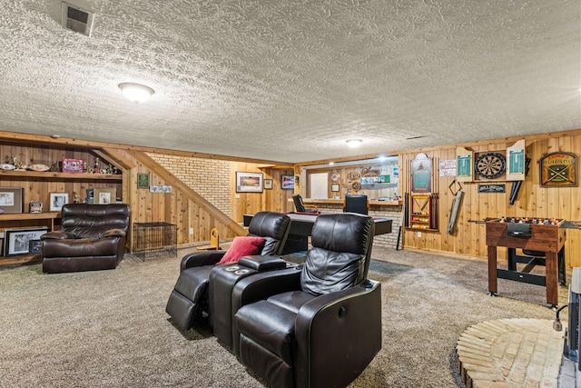 living room with carpet, a textured ceiling, and wood walls