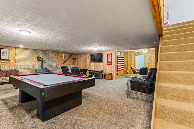 game room featuring wooden walls, carpet floors, a textured ceiling, and billiards