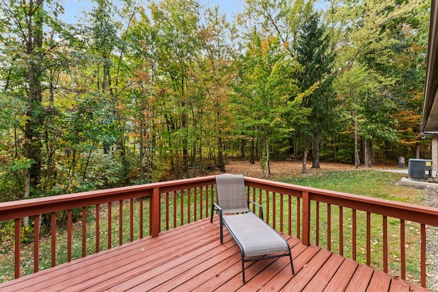 deck featuring a yard and cooling unit