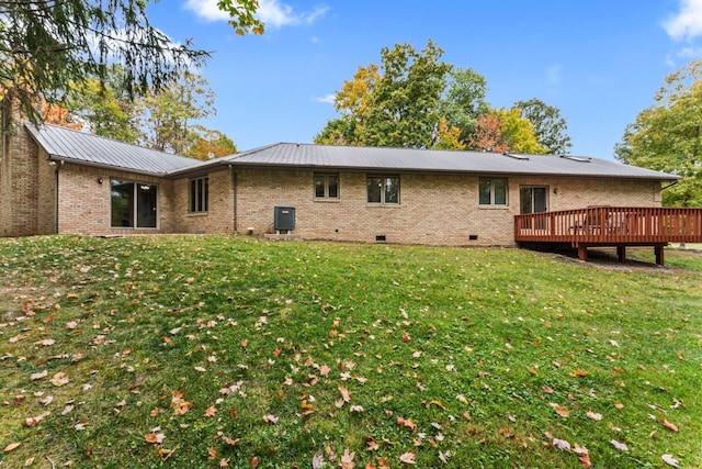 back of house with a lawn, central AC, and a wooden deck