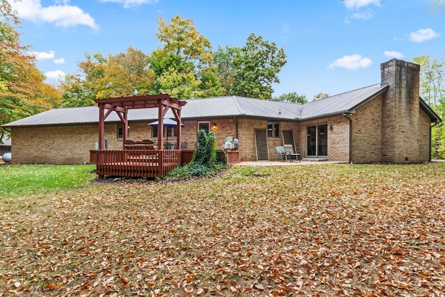 rear view of house featuring a deck, a pergola, and a patio