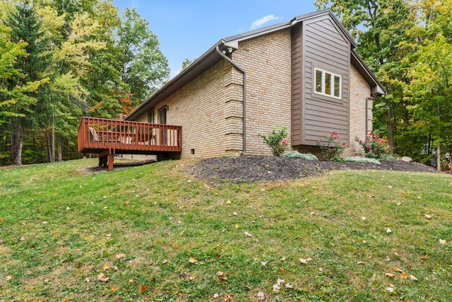 view of home's exterior with a lawn and a wooden deck