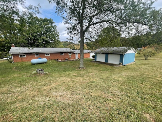 view of yard featuring a garage and an outdoor structure