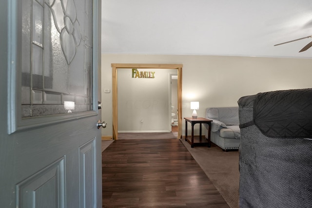 interior space featuring ceiling fan, dark hardwood / wood-style floors, and ornamental molding