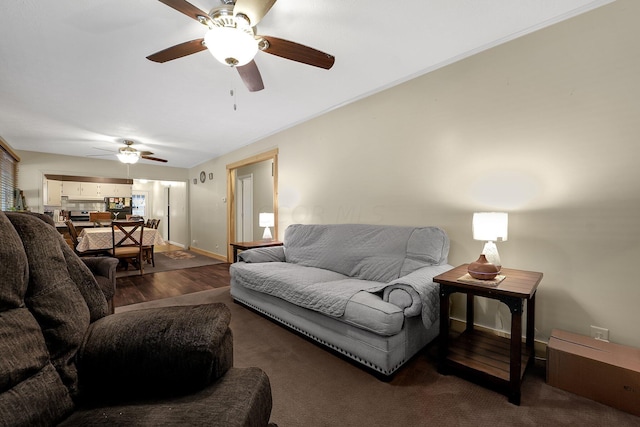 living room with dark hardwood / wood-style flooring and ceiling fan