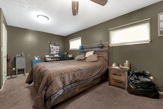 bedroom featuring carpet flooring, ceiling fan, and a textured ceiling