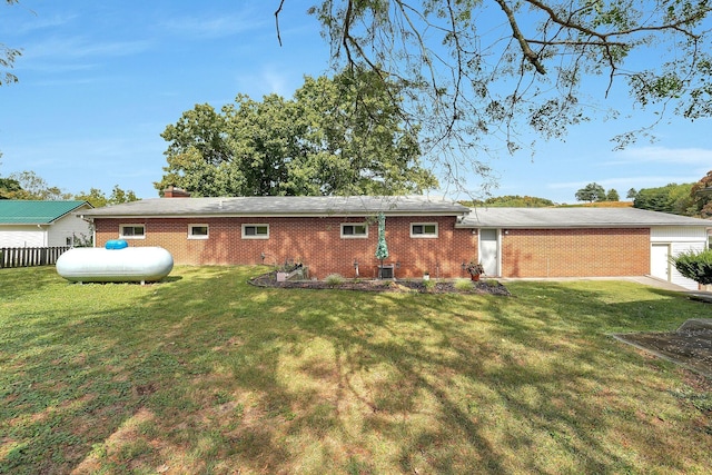 back of house with cooling unit and a lawn