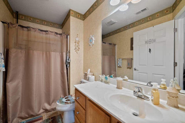 bathroom featuring a shower with curtain, toilet, and vanity