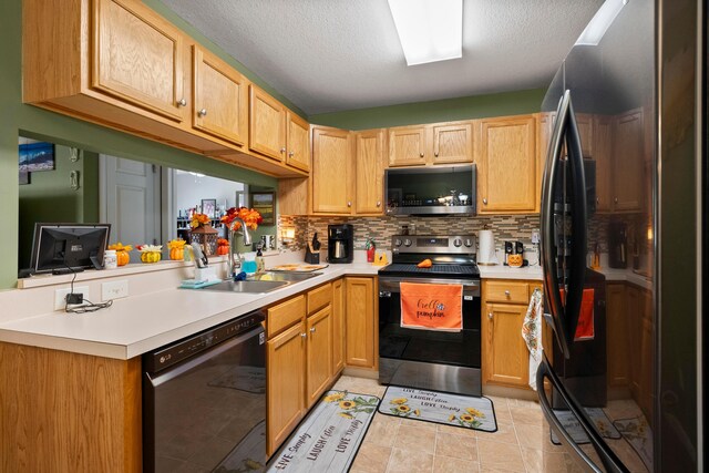 kitchen with sink, stainless steel appliances, a textured ceiling, decorative backsplash, and light tile patterned flooring