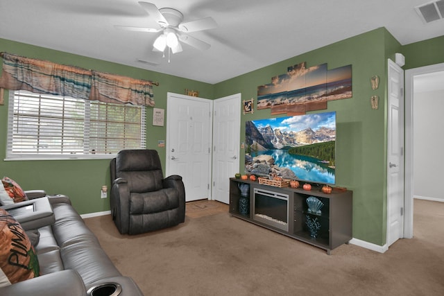 carpeted living room featuring ceiling fan