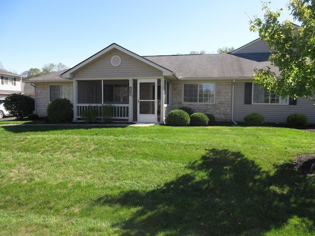 ranch-style house featuring a front yard and a sunroom