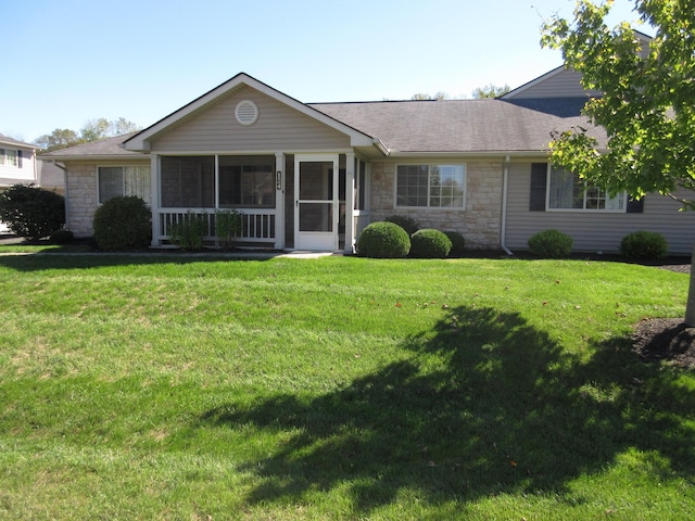 ranch-style home featuring a sunroom and a front yard