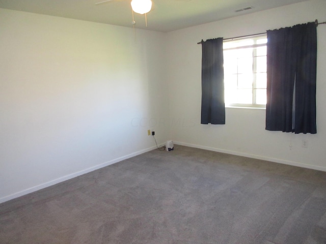 carpeted spare room featuring ceiling fan