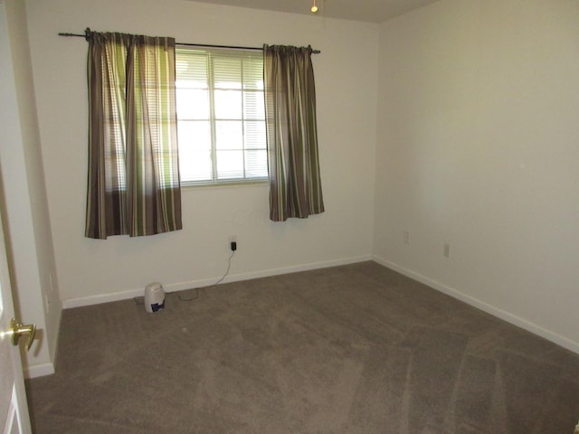 empty room with dark carpet