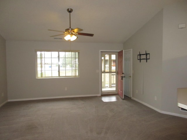 empty room with ceiling fan, carpet floors, and vaulted ceiling