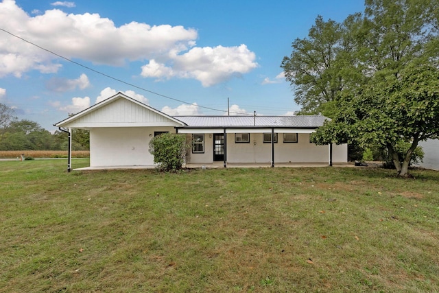 rear view of property featuring a porch and a lawn