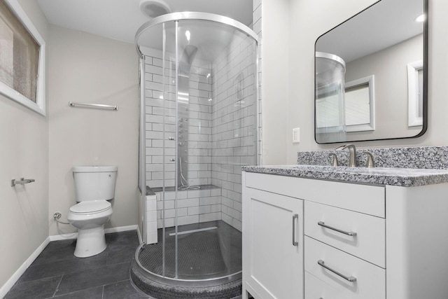 bathroom featuring toilet, vanity, tile patterned floors, and an enclosed shower