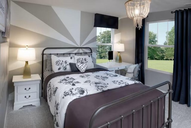 bedroom with a chandelier, multiple windows, and carpet floors