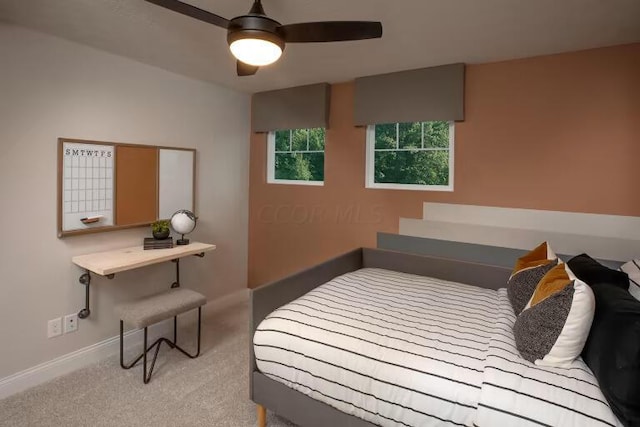 carpeted bedroom featuring baseboards and ceiling fan