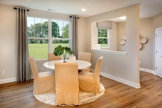 dining space with recessed lighting, wood finished floors, and baseboards