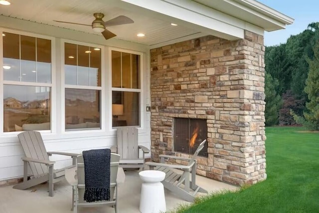 view of patio / terrace with an outdoor stone fireplace and ceiling fan