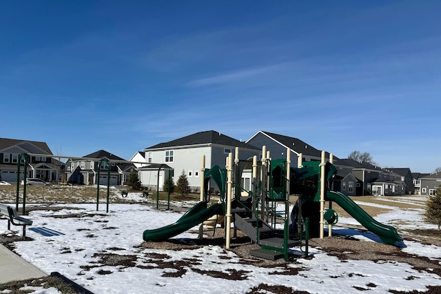 snow covered playground featuring playground community and a residential view