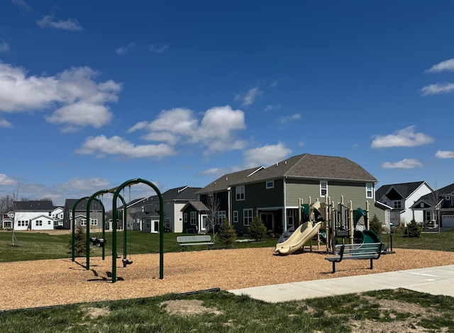 communal playground with a yard and a residential view