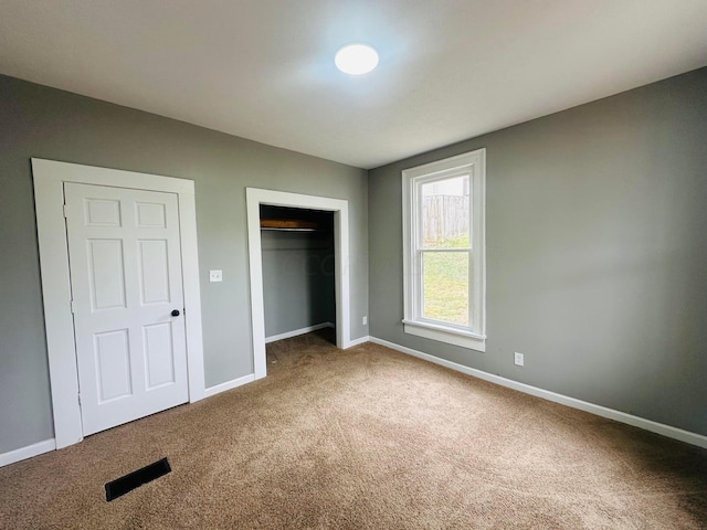 unfurnished bedroom with carpet and a closet