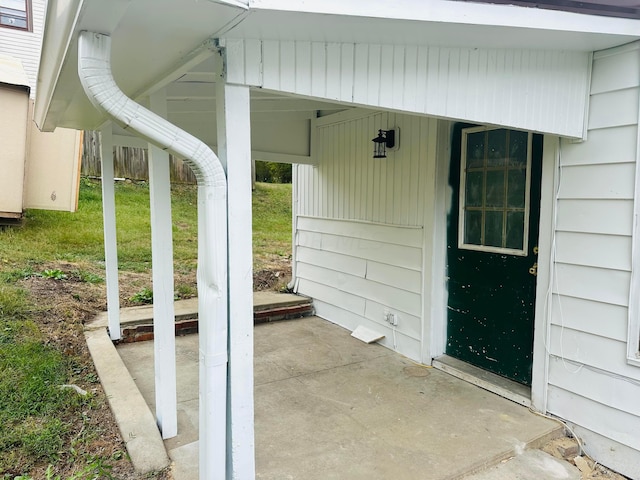 entrance to property with a lawn