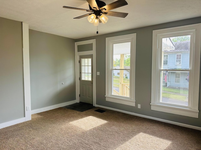 entryway featuring carpet flooring and ceiling fan