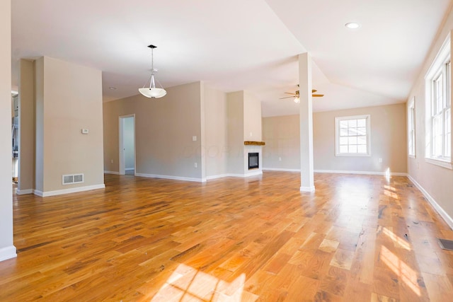 unfurnished living room featuring light wood-type flooring, ceiling fan, and lofted ceiling