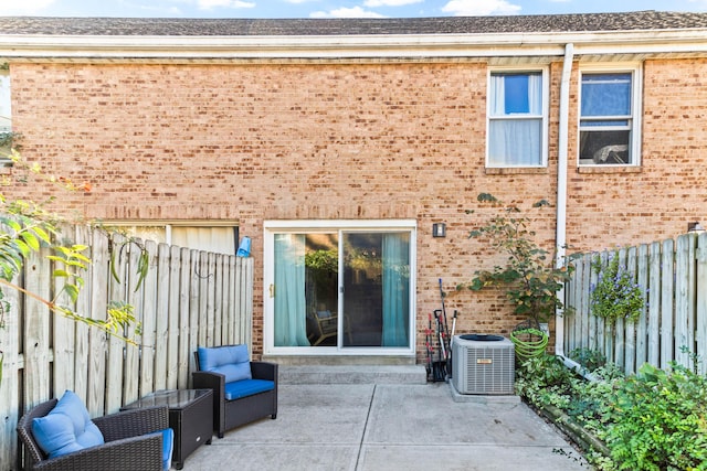 rear view of property featuring cooling unit and a patio area