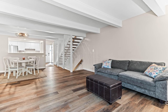 living room featuring beamed ceiling and dark hardwood / wood-style floors