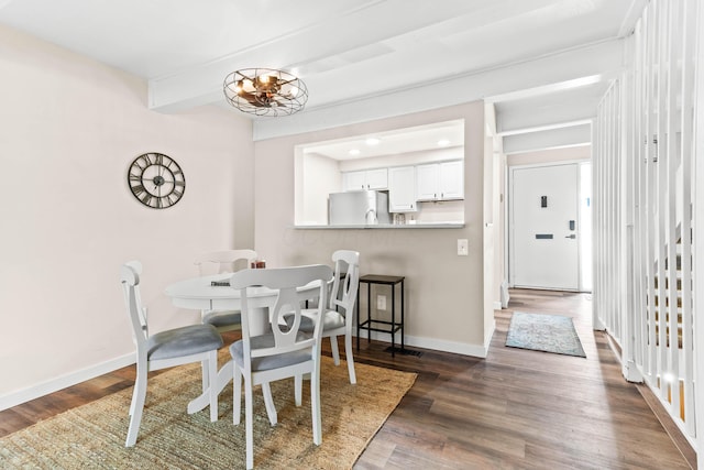 dining area with beamed ceiling, a notable chandelier, and dark wood-type flooring