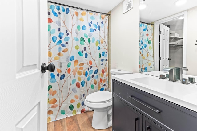 bathroom featuring hardwood / wood-style flooring, vanity, toilet, and a shower with curtain