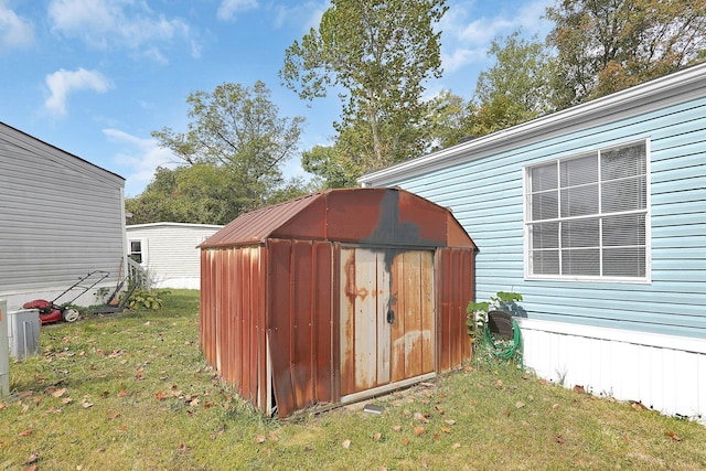 view of outdoor structure featuring a lawn